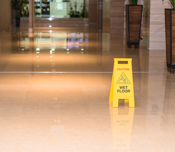 yellow Wet floor standing sign board kept in the floor