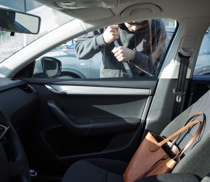 A man trying to break car's door