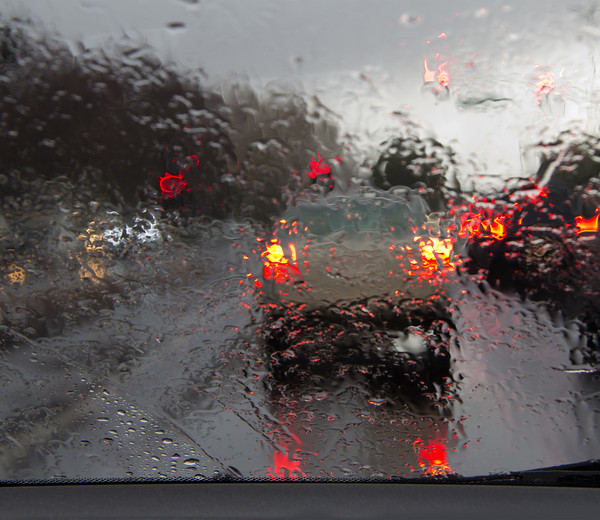 Blurry Image of a car's back on the road because it's raining